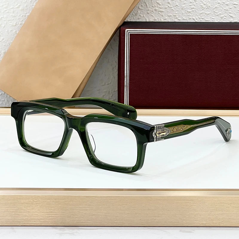 Green eyeglasses on a white surface with a textured wall and book in the background