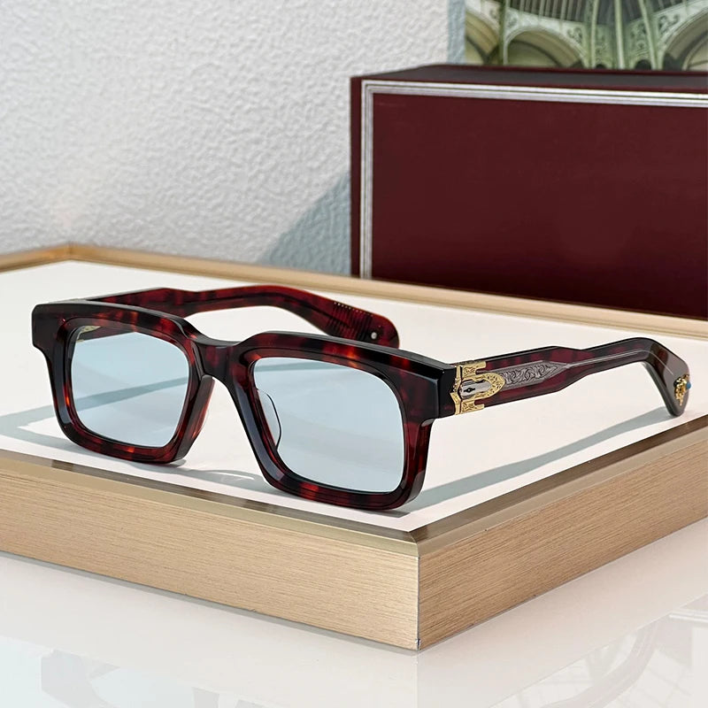 Sunglasses with tortoiseshell frame and blue lenses on a wooden surface.