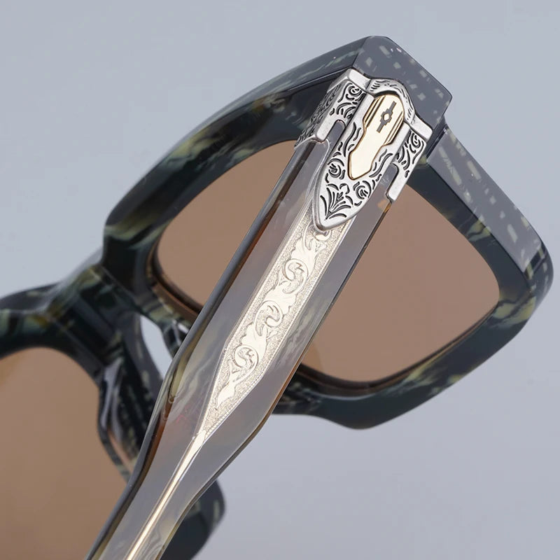 Sunglasses with decorative metal frame on a light gray background