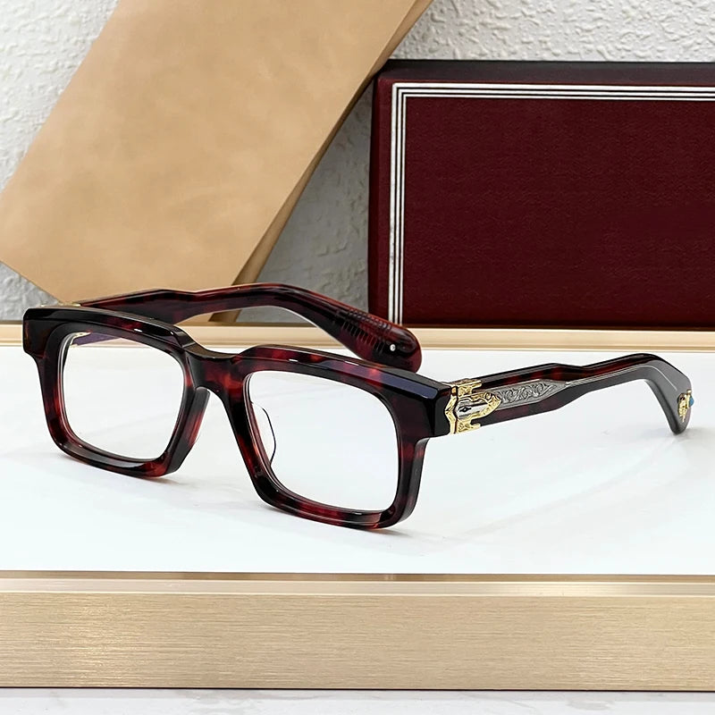 Tortoiseshell eyeglasses on a white surface with a textured wall background
