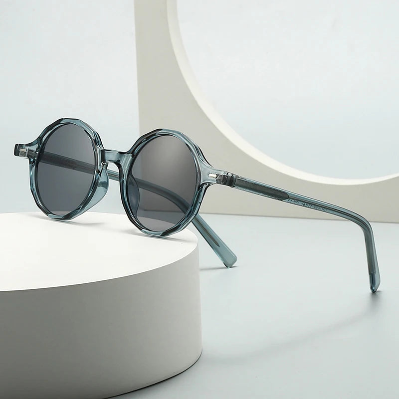 Round sunglasses with a transparent frame on a white surface